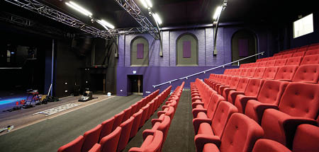Side view of the Hub theatre tiered auditorium seats and open stage