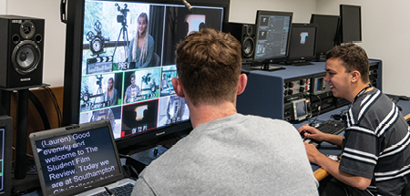 Students working in the TV editing suite, on the screen you can see various camera angles of people in a studio