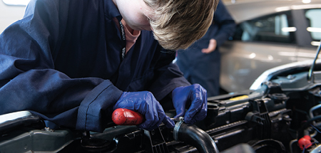 Student works on a car’s radiator