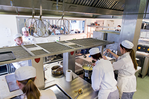 Overhead view of students working in a busy restaurant kitchen