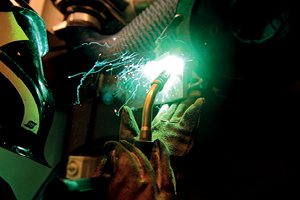 Green light comes from a welding torch in use