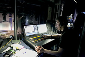 A student operates the sound desk